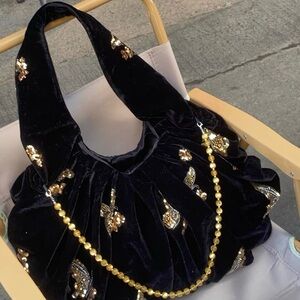 Elegant Black Velvet Bag with Gold Accents